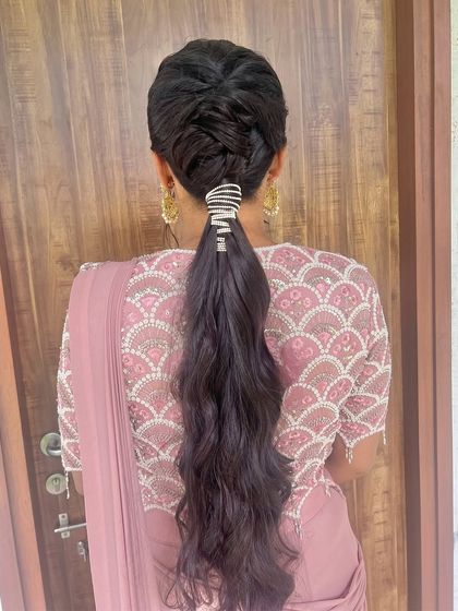 A modern braided ponytail, combining the elegance of a braid with the playfulness of a pony.