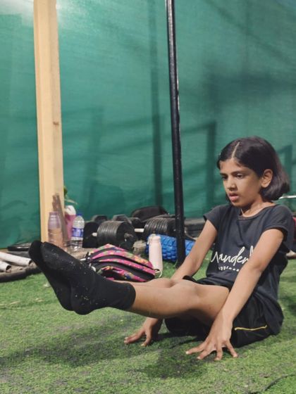Even our youngest athletes learn the importance of core strength. This young girl is working on her tuck sit, a progression towards the full L-sit.
