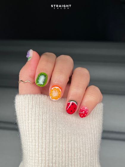 A fun and fruity manicure perfect for summer. Each nail is hand-painted to look like a different slice of fruit, from kiwi to watermelon.
