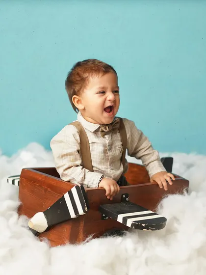 A moment of pure joy from our little pilot! His wide-open laugh shows the fun we have during these creative milestone sessions.