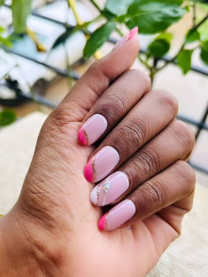 A chic and modern design on natural nails. This look combines a neutral pink base with angled hot pink tips and a delicate silver line to separate them. A subtle marble effect on the accent nail adds an artistic touch.