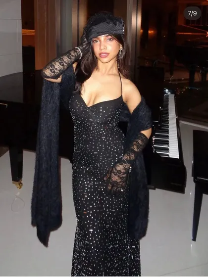 A full-length shot of the vintage-inspired black sequin gown. Paired with a fur stole, lace gloves, and a veiled hat, this is a complete, curated look for a themed party or a high-fashion event.