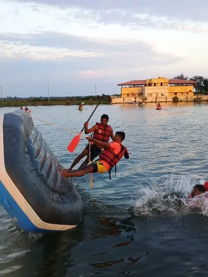 Participants practice a rescue technique, helping a person back into a raft that is on its side. These hands-on drills build confidence and skill.