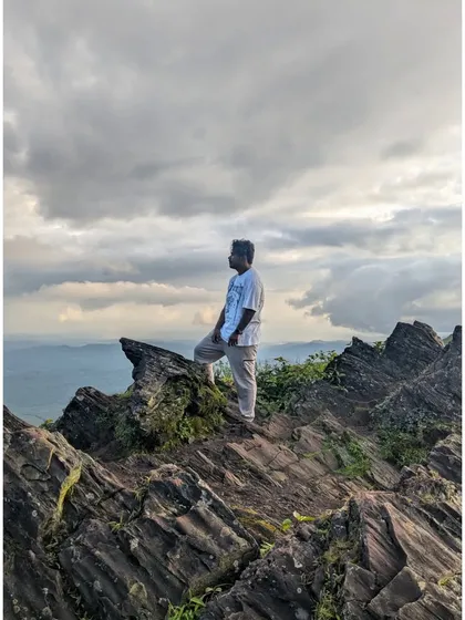 Standing on the rocky outcrops of a Chikmagalur peak, feeling the wind and admiring the vast landscape below. These are the moments of connection with nature that we seek on every trek.