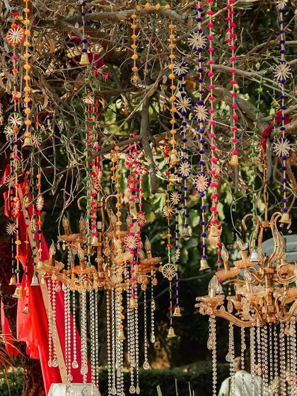 More of the enchanting tree decor, with multiple chandeliers and colourful hangings creating a festive canopy for the celebration below.