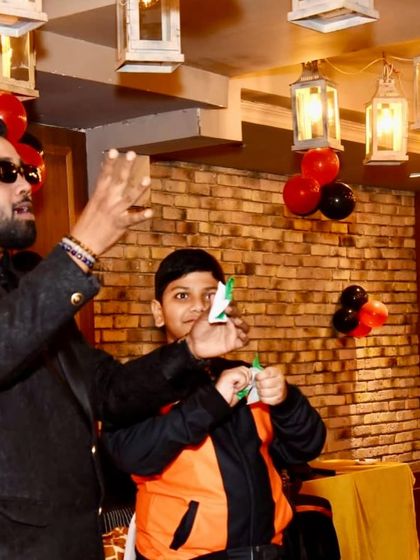 A close-up of the paper-tearing trick. The focus and participation of the volunteer are what make the illusion so effective.