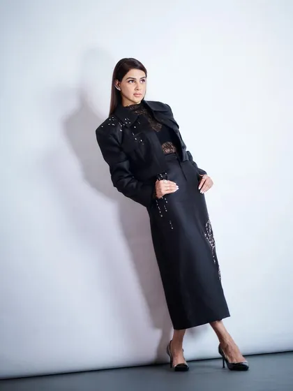 Genelia D'Souza in a full-length shot, showcasing the modern silhouette of her embellished jacket and skirt from Shop MMVM. The look is perfect for a high-fashion editorial.