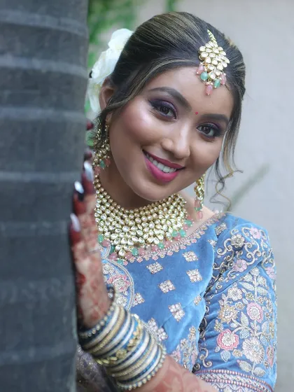A happy smile from a model during a student's portfolio shoot. The purple smokey eye and glowing skin look absolutely fantastic.
