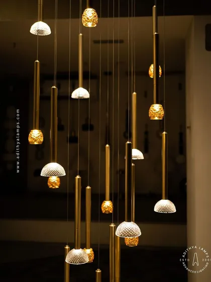 The warm glow from the textured glass pendants creates an inviting atmosphere. This image captures the ambient quality of the chandelier, perfect for living or dining areas.