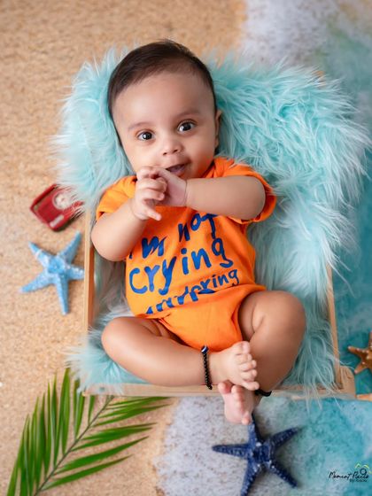 The sweetest beach baby. This little one in his funny "I'm not crying" onesie is enjoying a day at the 'beach' in my studio.