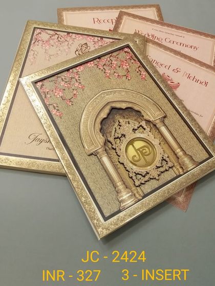 This luxurious invitation features a deep, 3D-carved archway with a custom monogram, set in a gold frame. The card and its three inserts have a rich, textured feel, perfect for a grand celebration.