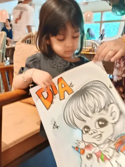 A little girl named Dia looks at her unicorn-themed caricature. I can incorporate favorite themes like unicorns or superheroes to make the drawing perfect for any child.