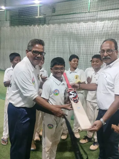 Presenting a new bat to Parth Rane for his outstanding century, where he scored 108 runs off 66 balls and also took a wicket.