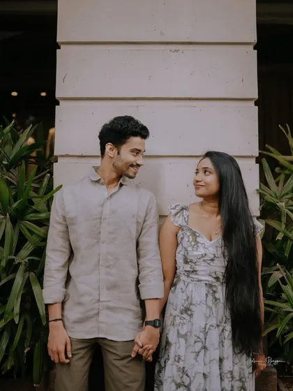 A sweet moment of connection. This candid shot captures the loving gaze between the couple during their pre-wedding shoot in the streets of Mumbai.