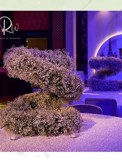 Another view of the sculptural baby's breath centerpiece, showing its unique, organic form.