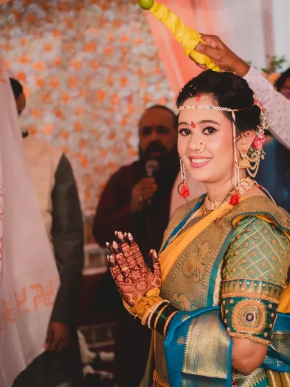 A happy bride during her wedding rituals. Her smile is infectious, and her makeup is designed to be radiant and long-lasting for the entire celebration.