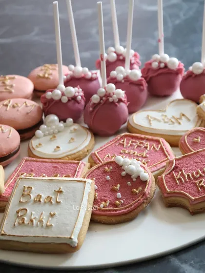 This platter is a whole vibe. It features custom cookies in heart, square, and hexagon shapes, plus my super popular cake pops and macarons.