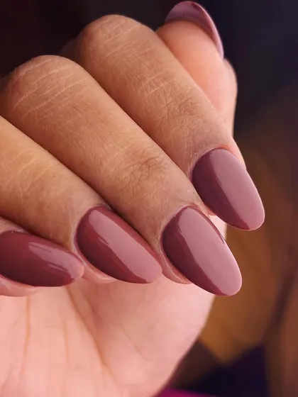 As rich and decadent as dark chocolate. This manicure features a deep, glossy brown polish that is both sophisticated and on-trend, perfect for a chic, modern look.