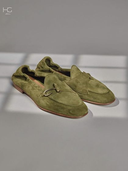 Stepping into style and comfort. These olive green suede loafers are designed for a relaxed yet sophisticated look, proving that casual footwear can still be luxurious.