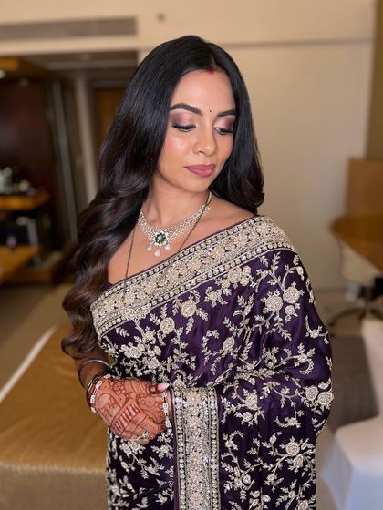 A side profile showing the soft, blended eye makeup and the beautiful flow of her hair. This is a classic and sophisticated look for any wedding guest or bride.