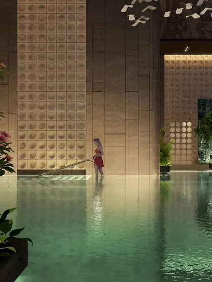 A detail of the Palais Royale pool, showing the shallow wading area for children. The space is designed with safety and luxury in mind, featuring textured walls and soft lighting to create a calm and inviting atmosphere.
