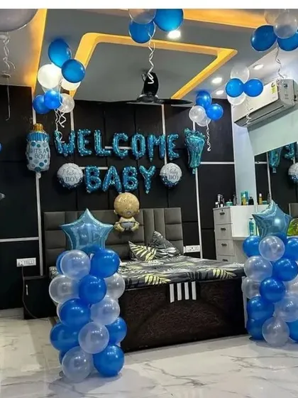 A 'Welcome Baby' bedroom decoration for a baby boy, with blue and white balloons and foil letters.