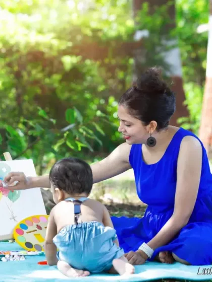 A mother and her baby boy are having fun with a painting set during their outdoor session. I use activities like this to capture genuine smiles and interactions.