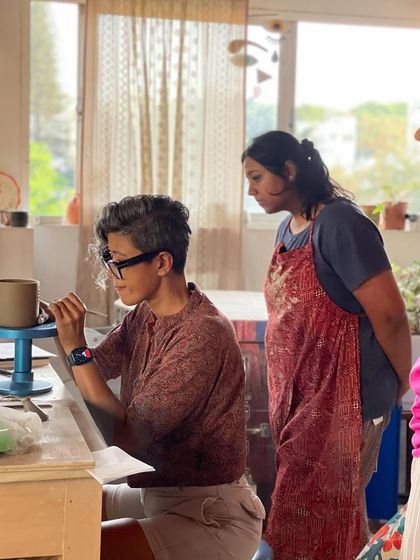A moment of focused instruction, as I demonstrate a trimming technique to a student, sharing the finer details of the craft.