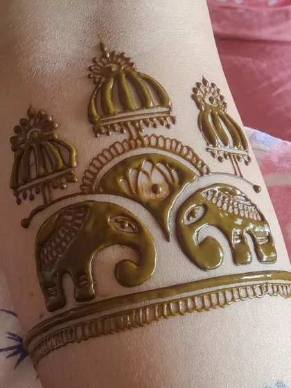 A close-up of this elephant family arm band, with no filter added. You can see the clean lines and the beautiful color of the fresh, natural henna.