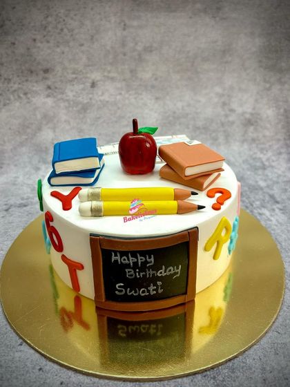 A sweet tribute for a teacher's birthday. This cake is decorated with edible books, pencils, an apple, and a mini chalkboard, all made from fondant.