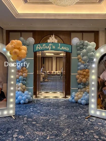 The personalized entrance to "Aviraj's Land," with illuminated photo frames creating a beautiful gallery walk for guests.