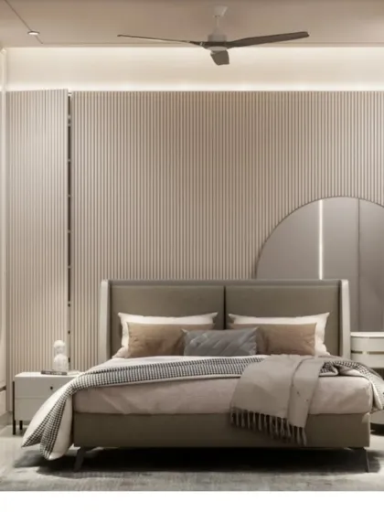 A 3D render of a master bedroom in Malad. The design features a serene, minimalist aesthetic with a fluted wall panel, a large round mirror, and a comfortable upholstered bed.