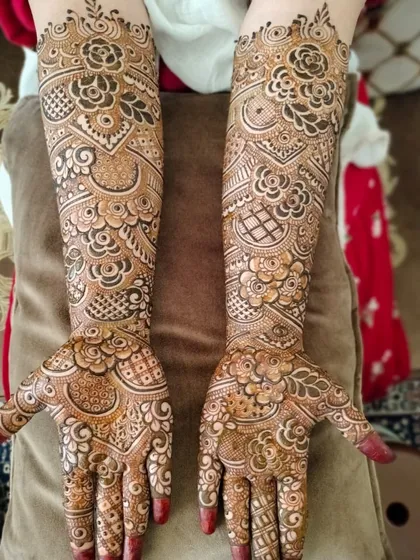 The final look of a beautiful bridal hands design. The pattern is a mix of traditional Indian and floral elements, with careful attention to symmetry and detail.