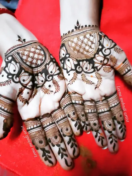 A fancy, modern design for the back of the hands. The pattern uses negative space to create a bold look, with lotus and grid motifs.