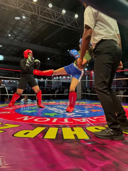 A perfectly executed kick during a tournament match. We train not just for power, but for precision and timing to score points and control the fight.