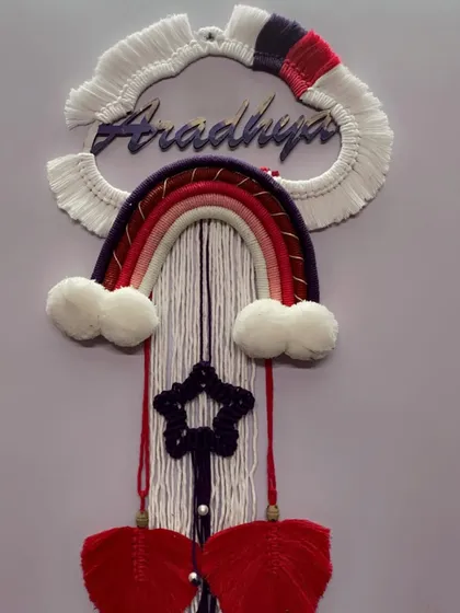 Another angle of the 'Aradhya' nameplate, showing the details of the knotted star and the texture of the fringed cloud.