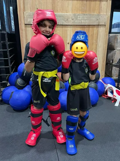 Little warriors in training. Two young students pose in their full sparring kit, proud and ready for action.