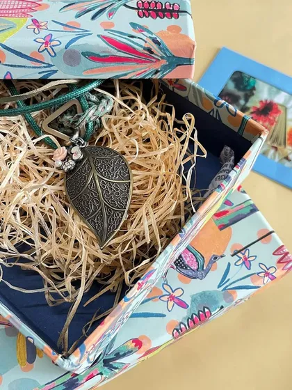 Gifting is easy with our beautiful storage boxes. This one from the 'Indian Savannah' collection is shown with a leaf-motif necklace, nestled in natural straw.