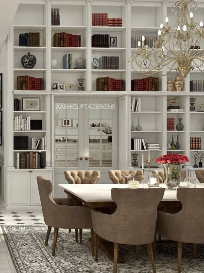 This dining room combines the formality of a grand library with the function of a dining space. The wall-to-wall white shelving is filled with books, creating a sophisticated and intellectual atmosphere for any meal.