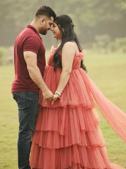 An intimate moment between the couple. The soft, romantic feel of the gown is perfect for capturing the love and excitement of expecting a child.