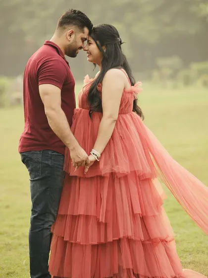 An intimate moment between the couple. The soft, romantic feel of the gown is perfect for capturing the love and excitement of expecting a child.