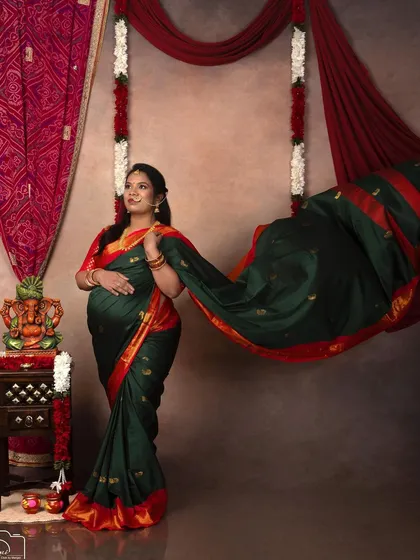 A dynamic shot with the saree's pallu flowing in the wind, adding a touch of drama and elegance to this traditional portrait.