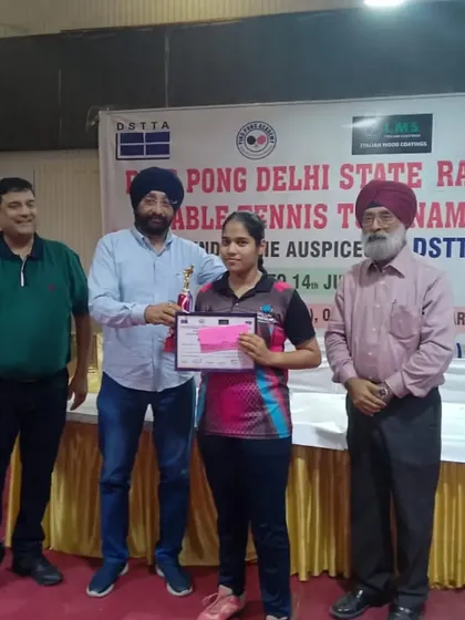 A proud moment as Ayushi receives her trophy at the Delhi State Table Tennis Ranking tournament.