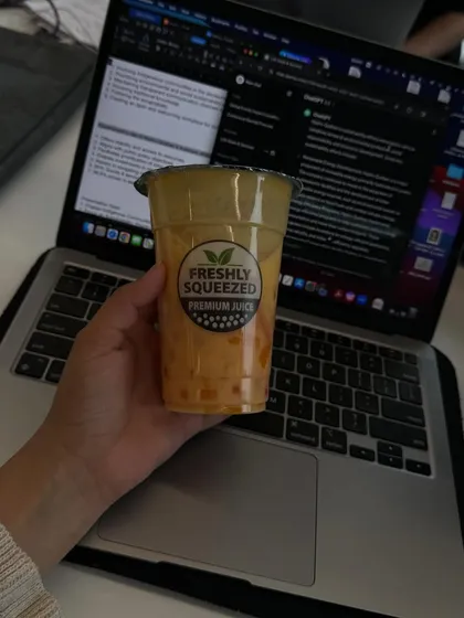 A shot of a laptop and a drink, representing the "study life" aspect of being a student.