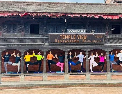 The group holding Vrikshasana (Tree Pose) in front of the Temple View Restaurant in Bhaktapur. This demonstrates how we integrate our yoga practice into every part of our journey.