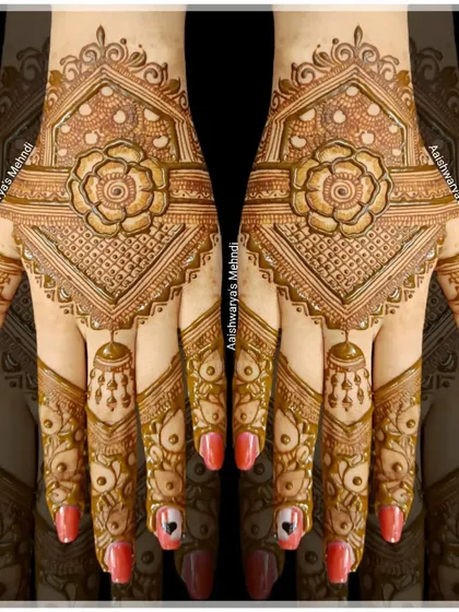 A stunning back-hand design with a large central flower and hanging jhumka motifs on the fingers. It's a very regal and eye-catching style.