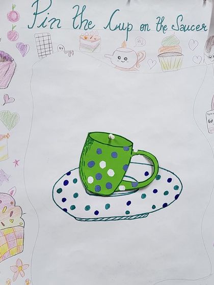 A handmade "Pin the Cup on the Saucer" game, created just for the party. This is one of the many themed activities we design to keep the children entertained and engaged.