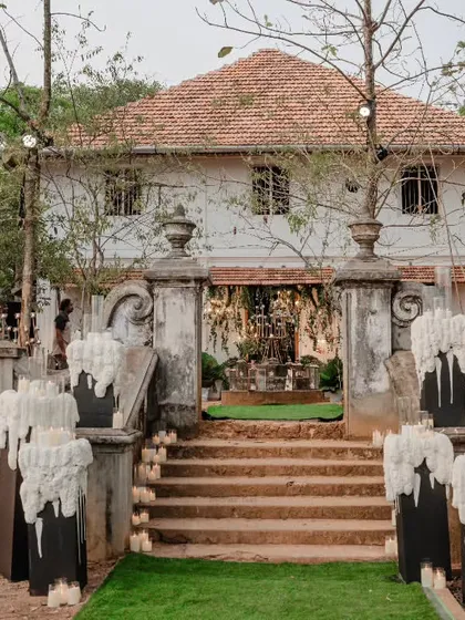 The magic begins to unfold as day turns to night. This entrance features pillars with unique melted wax floral designs, hinting at the romantic celebration to come.