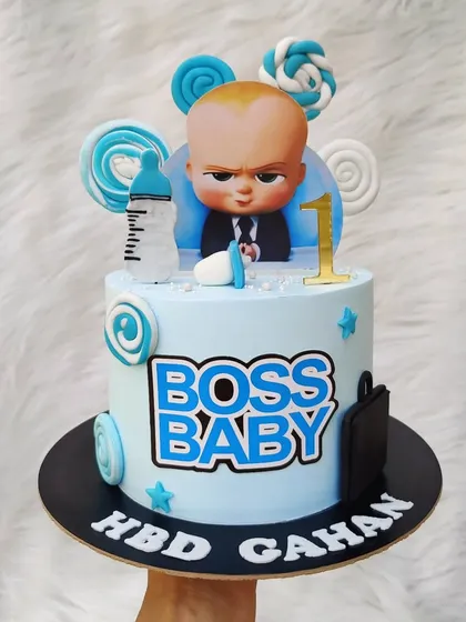 The Boss Baby theme is always a hit for first birthdays. I use a combination of printed character toppers and handmade fondant details like the bottle and briefcase to bring the theme to life on a smooth buttercream base.