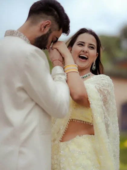 A candid moment filled with movement and laughter. This shot from an engagement shoot captures the dynamic energy and happiness of the couple as they dance and celebrate together.